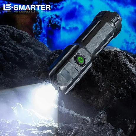 Rechargeable LED tactical flashlight illuminating rocky terrain, showcasing its durable design and adjustable focus.