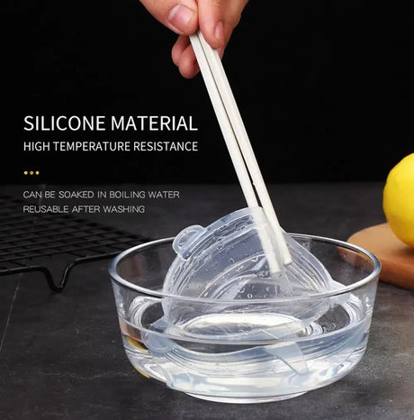 Silicone stretch lid being lifted from a bowl, showcasing high temperature resistance and easy cleaning.