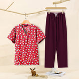 Cartoon print dental scrubs set featuring a red top with playful designs and matching pants, ideal for pet grooming professionals.