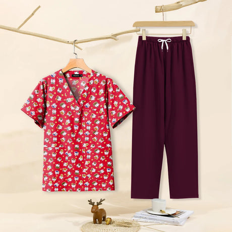 Cartoon print dental scrubs set featuring a red top with playful designs and matching pants, ideal for pet grooming professionals.