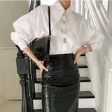 Model showcasing PearlEdge™ pearl-button shirt, styled with a black leather skirt, highlighting Y2K fashion and Korean style.