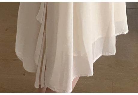 Detail of a short sleeve maternity dress, highlighting the flowing fabric and elegant design, perfect for summer photoshoots.
