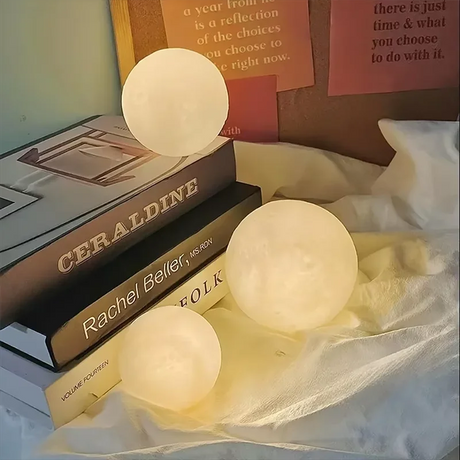 LED Moon Galaxy Book Light showcased on stacked books, adding a whimsical touch to decor and perfect for gifting.