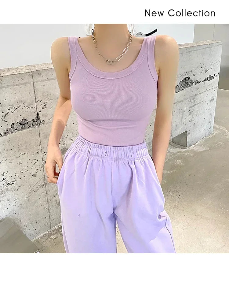Model wearing a sleeveless light purple ribbed tank top from RetroRib™, paired with relaxed lavender pants.