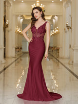 Elegant burgundy evening gown with lace embellishments and a mermaid silhouette, perfect for special occasions.