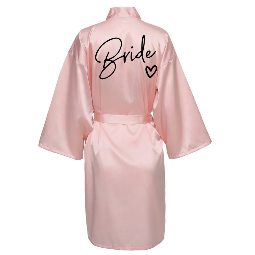 Pink satin robe with 'Bride' printed on the back, perfect for bridal parties and wedding mornings.
