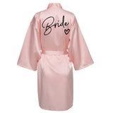 Pink satin robe with 'Bride' printed on the back, perfect for bridal parties and wedding mornings.