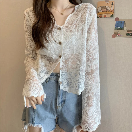 SheerCharm™ long sleeve lace sun shirt in white, featuring a V-neck and button closure, styled with denim shorts.