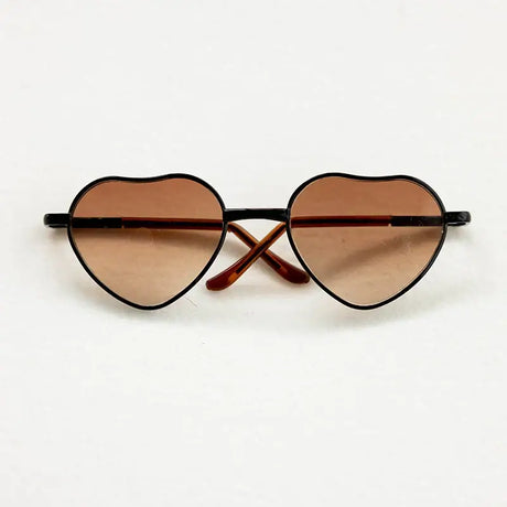 Heart-shaped baby sunglasses for newborn photography, perfect colorful accessory for gender-neutral photo shoots.
