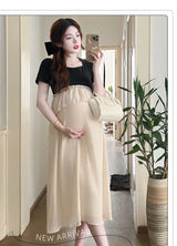 Short sleeve maternity dress for photoshoots, featuring black top and beige bottom, perfect for summer casual wear.