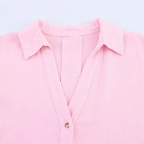 Close-up of a pink AsymLinen™ wide sleeve linen shirt with a turn-down collar and single breasted button closure.
