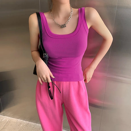 Model wearing a purple RetroRib™ 90s vintage ribbed tank top paired with pink sweatpants, showcasing streetwear style.