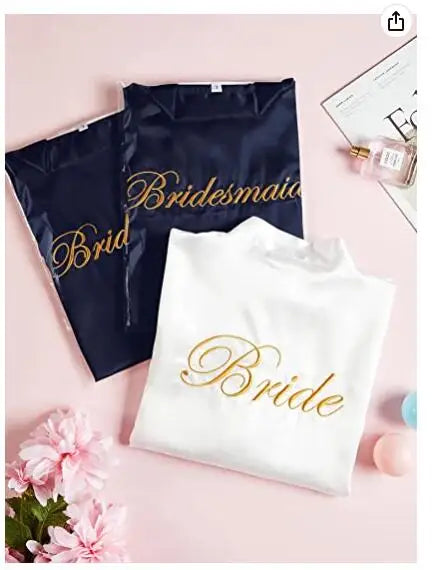 Bride and Bridesmaid robes in elegant packaging, featuring gold embroidery on white and navy fabrics.