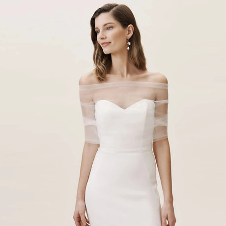 Model wearing VG73 sheer wedding jacket bolero over elegant bridal gown, showcasing a romantic and modern bridal style.