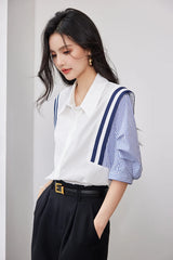 Woman wearing a colorblock chiffon shirt with navy blue and white stripes, styled for office casual look.