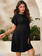 Stylish bat-sleeve black maternity tunic dress perfect for summer photoshoot, showcasing elegant and comfortable design.