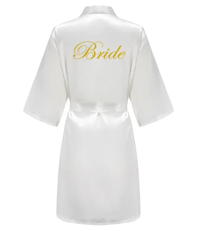 White satin robe with gold 'Bride' print on the back, perfect for wedding celebrations and bridal parties.