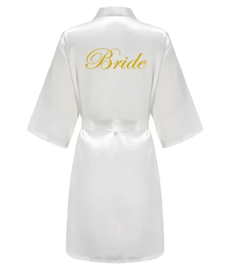 White satin robe with gold 'Bride' print on the back, perfect for wedding celebrations and bridal parties.