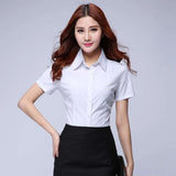 Woman wearing a white short sleeve shirt with a turn-down collar, perfect for youthful office style.