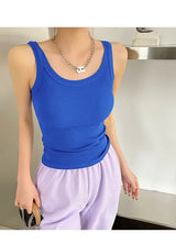 Blue sleeveless ribbed tank top paired with purple pants, showcasing a trendy streetwear style.