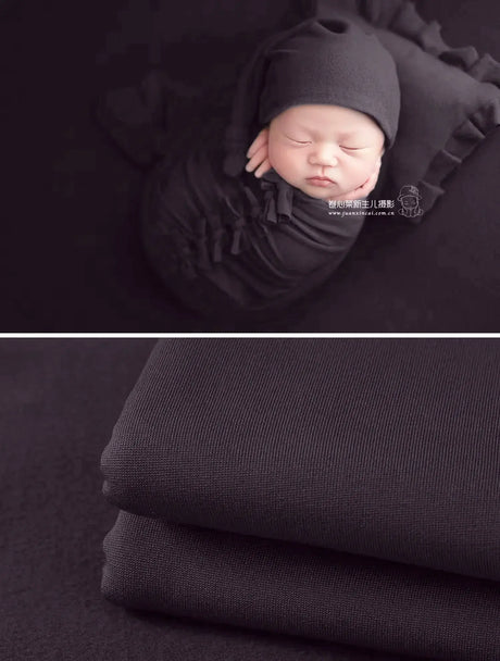 Newborn soft wrap blanket in black for photography, featuring a peaceful sleeping baby and soft texture.