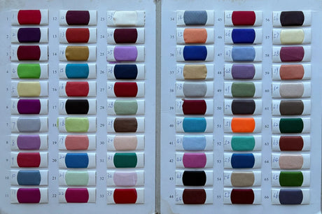 Color swatches showcasing a variety of fabric options for bridal gowns, including shades from pastels to deep hues.