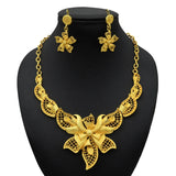 Luxury Indian bridal jewelry set featuring a 24K gold plated necklace and matching flower earrings.