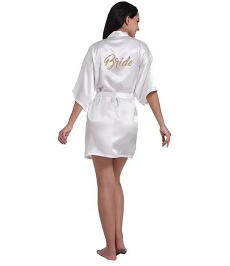 Back view of a bride wearing a satin robe with 'Bride' lettering, perfect for wedding preparations.