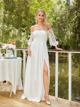 Off shoulder mermaid wedding dress in white with lace sleeves and side slit, showcased in a serene outdoor setting.