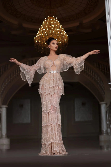 Elegant Arabic nude stone wedding gown with tiered sleeves, perfect for special occasions. Floor-length style with intricate details.