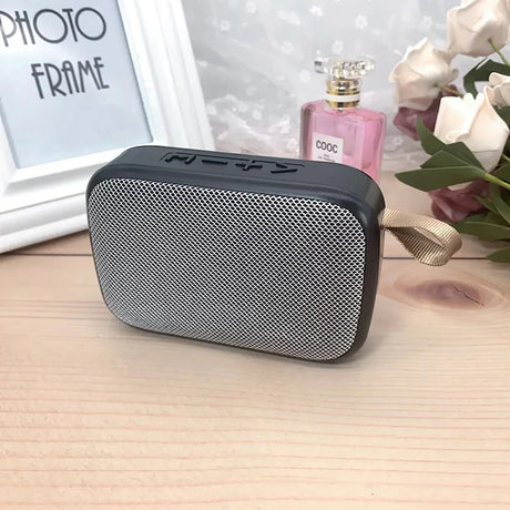 Portable outdoor Bluetooth 5.0 mini speaker with sleek design and strap, perfect for music on-the-go.