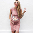 Smiling pregnant woman in a loose casual maternity dress with cartoon design, showcasing style and comfort for expectant mothers.
