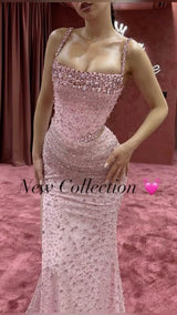 Elegant pink mermaid wedding dress with crystal beads and thin straps, showcasing luxury design and stunning silhouette.