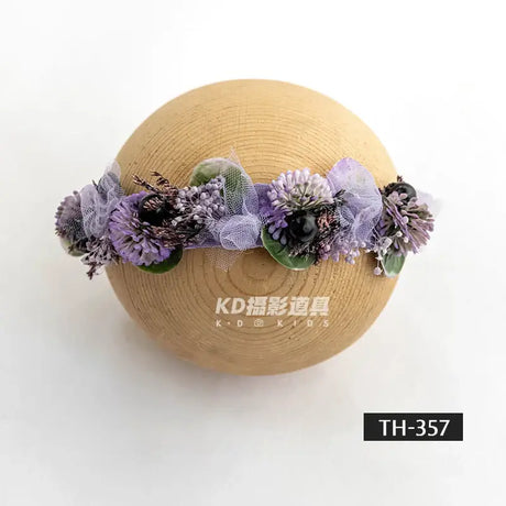 Adjustable faux flower headband for newborn girls, perfect for baby photography, featuring purple flowers.