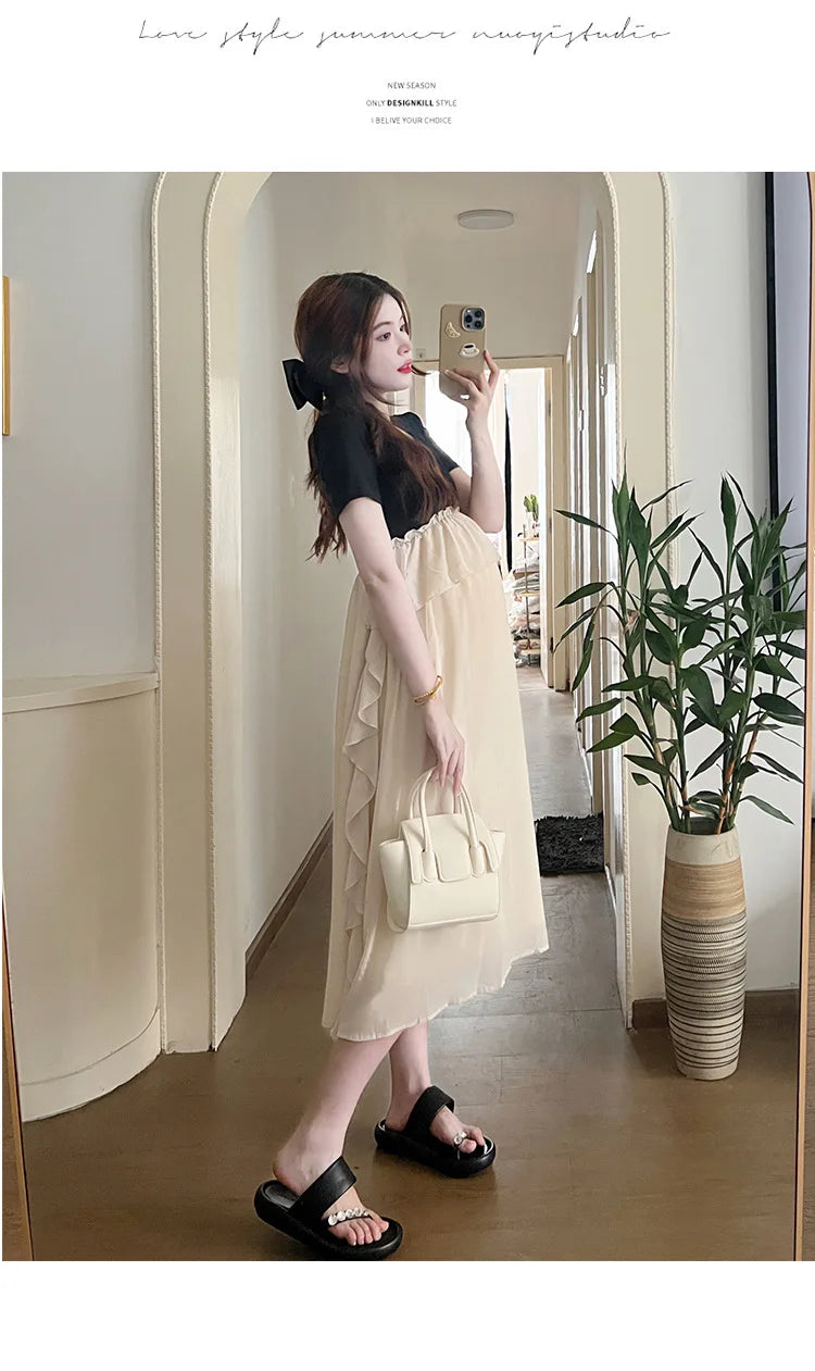 Short sleeve maternity dress in light color, showcasing casual summer style, perfect for expecting mothers.
