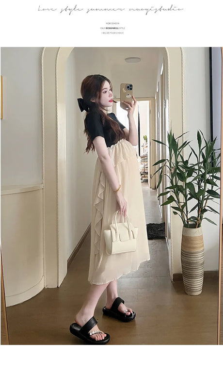 Short sleeve maternity dress in light color, showcasing casual summer style, perfect for expecting mothers.