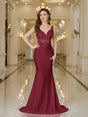 Elegant burgundy evening gown with intricate lace detailing and a fitted silhouette, set in an opulent interior.