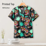 Colorful printed top in black with green pineapples and colorful patterns, made of 100% cotton, ideal for nurses.