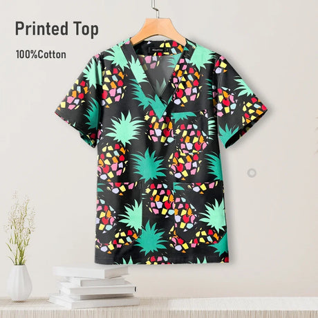 Colorful printed top in black with green pineapples and colorful patterns, made of 100% cotton, ideal for nurses.
