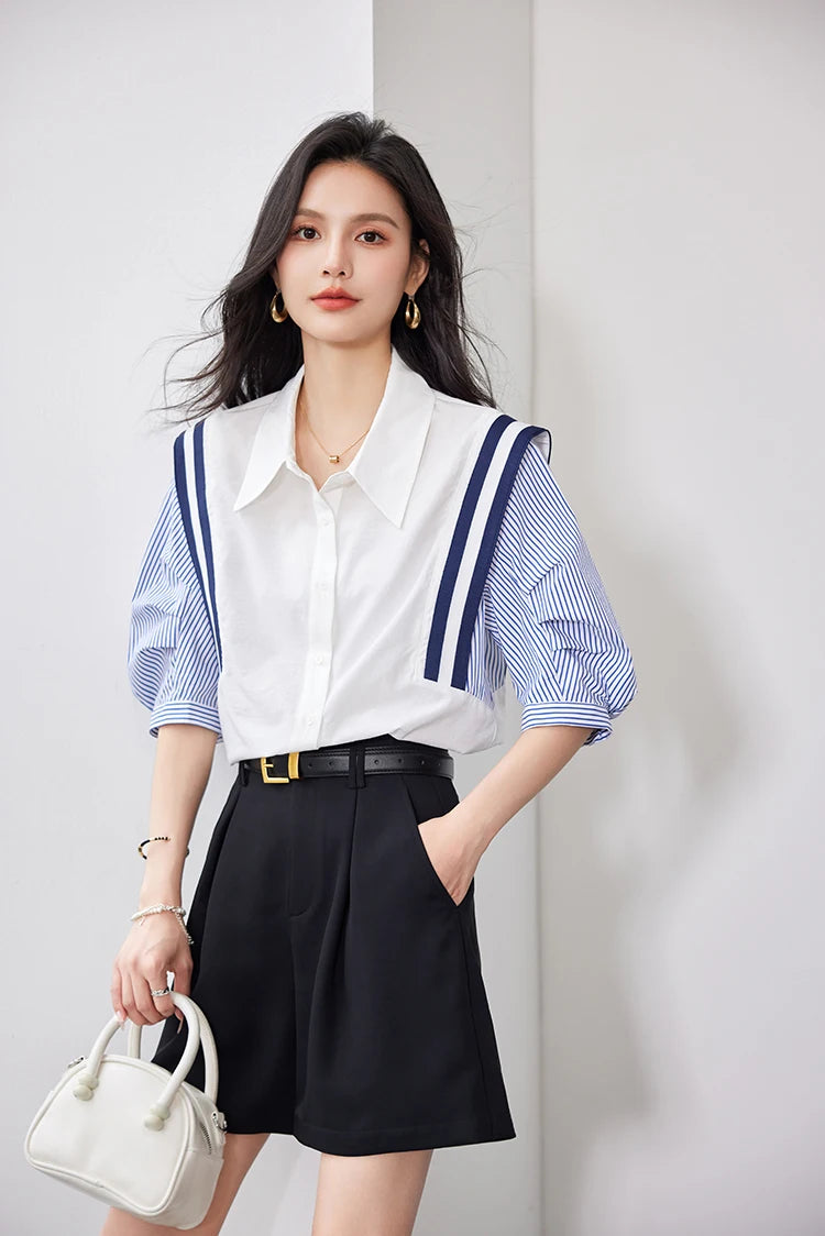 Woman wearing a stylish colorblock chiffon shirt with puff sleeves and a collar, paired with black shorts.