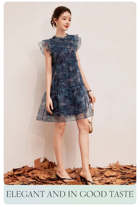 Woman wearing LOUIS YAO Sparkling Dress, an elegant flounced mini dress perfect for summer outings.