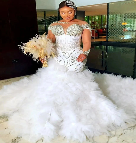 Elegant white plus size Arabic mermaid wedding dress with tulle skirt and crystal embellishments.