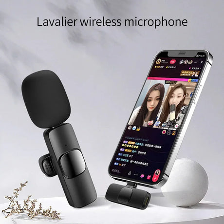 Wireless lavalier microphone displayed next to a smartphone used for streaming and social media.