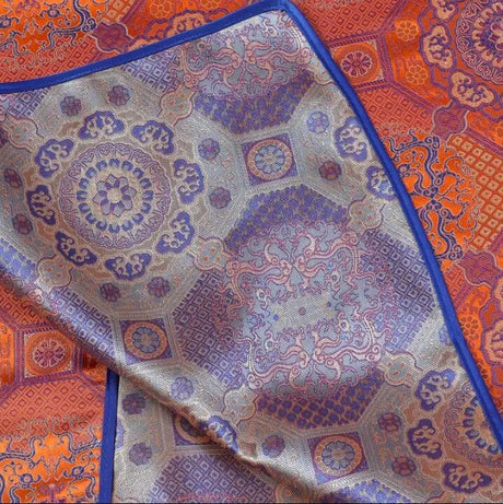 Close-up of vibrant Mongolian fabric showcasing intricate patterns and rich colors, ideal for traditional women's clothing.