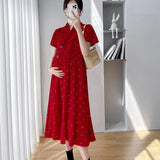 Polka dot red maternity dress with short sleeves, v-neck, and high waist, perfect for summer wear.