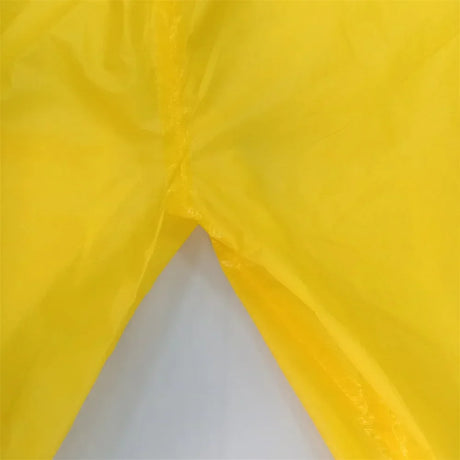 Close-up of yellow waterproof work coverall, showcasing durable fabric for chemical resistance and safety.