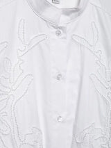 Elegant white embroidery shirt with stand collar and single-breasted closure, showcasing intricate floral details.
