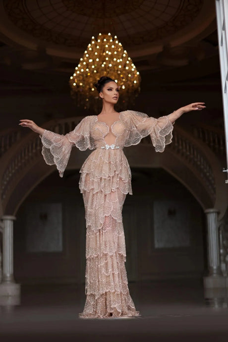 Elegant Arabic nude stone wedding gown with tiered sleeves and sweetheart neckline, featuring intricate beading and floor-length design.