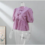 BowChic™ Stripe Lace-Up Blouse in purple and white stripes, featuring short puff sleeves and lace-up details.