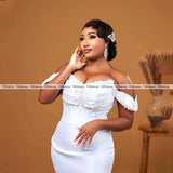 Elegant off-shoulder wedding dress with pearls and detachable train, showcasing a stunning mermaid silhouette.